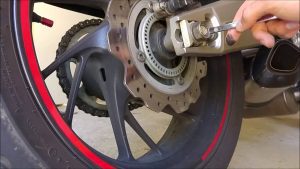 tighten your technical motorcycle chain nut against nut